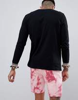 Thumbnail for your product : ASOS DESIGN festival relaxed longline long sleeve t-shirt with pom-pom chest and cuff