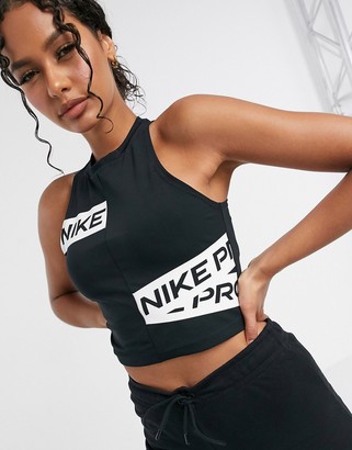 Nike Training Nike Pro Training crop top with logo taping in black -  ShopStyle