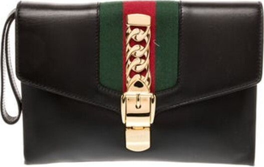 Gucci Clutch Black Leather Colorblock Pattern Web Accent Gold-Tone Hardware Wrist Strap Chain-Link Accents & Single Exterior Pocket Suede Lining & Single Interior Pocket Turn-Lock Closure at Front Includes Dust Bag Unfortunately due to restrictions this item may not be eligible for shipping in all areas.