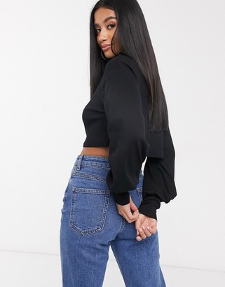 ASOS DESIGN Petite relaxed crop top with slouchy roll neck in soft rib in black