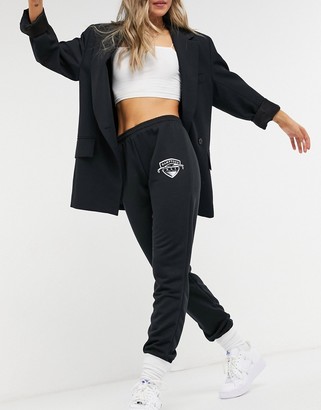 ASOS DESIGN low rise sweatpants with logo in black - ShopStyle Pants