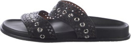 Alaia Leather Slides Black Lasercut Accents Crossover Straps Unfortunately, due to restrictions, this item may not be eligible for shipping in all areas.