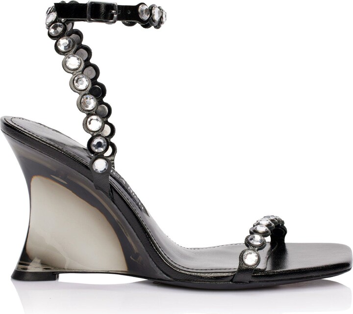 JESSICA RICH The Diamond Wedge is the latest show-stopping design from Rows of rhinestones set against an angular, Lucite wedge heel make this shoe both edgy and elegant.