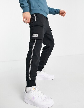 Nike Repeat logo taping cargo joggers in black - ShopStyle Trousers