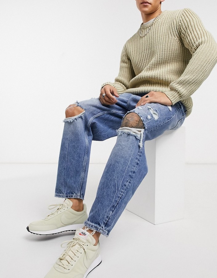 Bershka loose fit jeans with rips in mid blue wash - ShopStyle