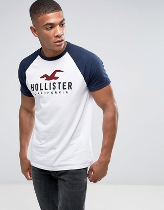 Hollister Crew T-Shirt Baseball Tech Logo Slim Fit In White/Navy
