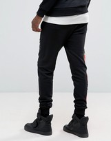 Thumbnail for your product : Criminal Damage Skinny Joggers In Black With Rose Print