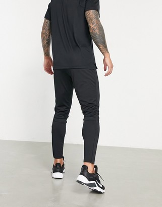 Nike Football Academy tapered joggers in black - ShopStyle Trousers