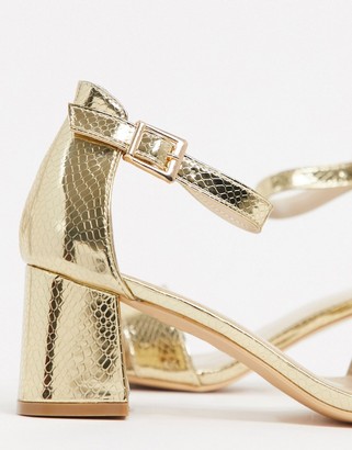 Glamorous mid heeled sandals in lizard embossed gold