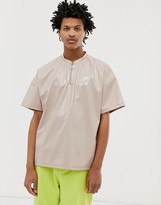 Thumbnail for your product : ASOS DESIGN oversized t-shirt with half sleeve and zip neck in vinyl fabric