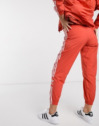 adidas adicolor locked up logo track pants in red - ShopStyle