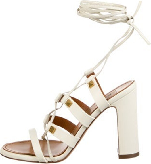 Valentino Leather Gladiator Sandals White Rockstud Accents Studded Accents Wrap-Around Straps & Tie Closures Unfortunately, due to restrictions, this item may not be eligible for shipping in all areas.