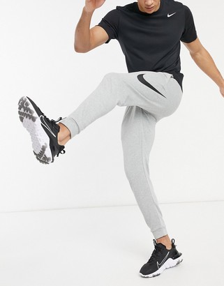 Nike Training Swoosh joggers in grey - ShopStyle Trousers