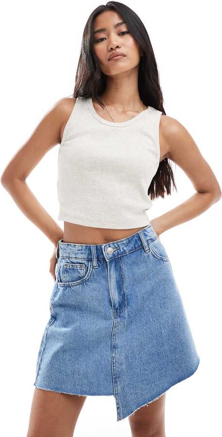 Pieces asymmetric hem detail denim mini skirt in light blue wash