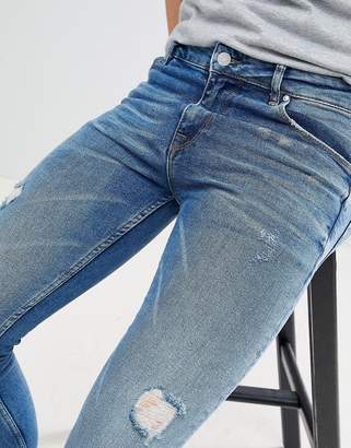 ASOS DESIGN super skinny jeans in dark wash blue with abrasions