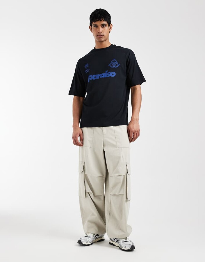 ASOS DESIGN oversized T-shirt with soccer graphic in black