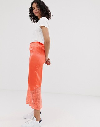 ASOS DESIGN bias cut satin midi slip skirt with lace hem in neon orange
