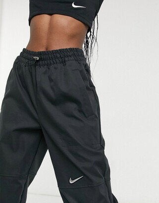 Nike Swoosh woven joggers in black - ShopStyle Activewear Pants