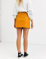 Thumbnail for your product : ASOS DESIGN wrap A line leather look mini skirt with snap buttons