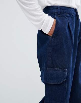 ASOS DESIGN tapered jeans with curved seam in indigo wash with utility pockets