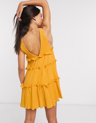 ASOS DESIGN button front tiered mini sundress in textured crinkle in mustard