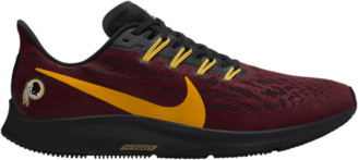 gold black nike shoes