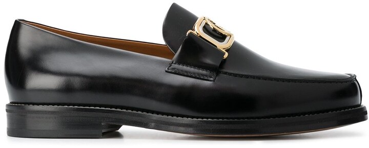 black loafers with gold buckle