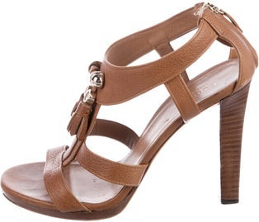 Gucci Leather T-Strap Sandals Brown Tassel Accents Multistrap & Exposed Zip Closure at Ankles Unfortunately, due to restrictions, this item may not be eligible for shipping in all areas.