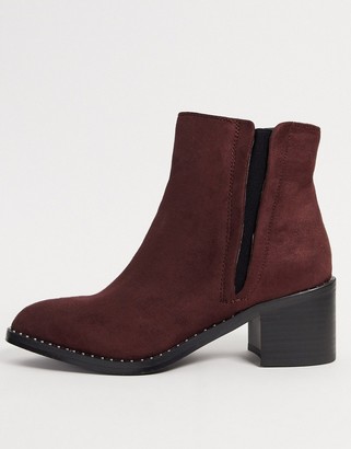 Call it SPRING crareweth heeled ankle boots with studded rand in red