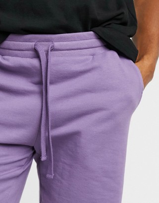 ASOS DESIGN jersey slim shorts with raw hem and flat drawcords in purple