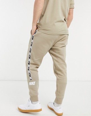 Nike Repeat Pack taping cuffed joggers in stone - ShopStyle Trousers