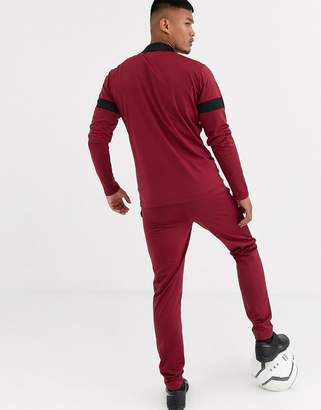 Puma Football tracksuit in burgundy with black panels exclusive to ASOS