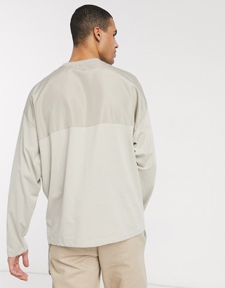 ASOS DESIGN oversized long sleeve t-shirt with woven utility pockets in beige