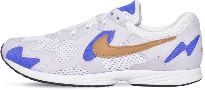 black nike shoes with gold tick