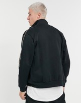 Thumbnail for your product : Puma track jacket in black with gold taping