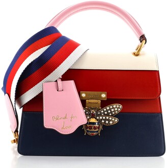 small red bolsa with handle