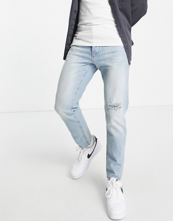 ASOS DESIGN tapered jeans in vintage light wash with rip - ShopStyle