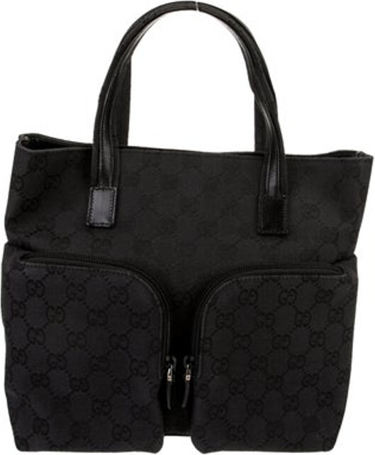 Gucci Top Handle Bag Black Canvas GG Canvas Multitonal Hardware Leather Trim Flat Handles Leather Trim Embellishment & Dual Exterior Pockets Nylon Lining & Single Interior Pocket Snap Closure at Top