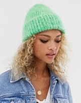 Thumbnail for your product : ASOS DESIGN fluffy two tone beanie hat in green