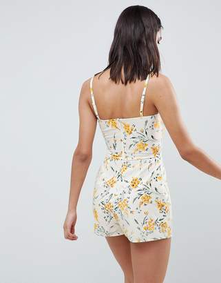 ASOS Design DESIGN cami playsuit with cut out detail in linen in floral print