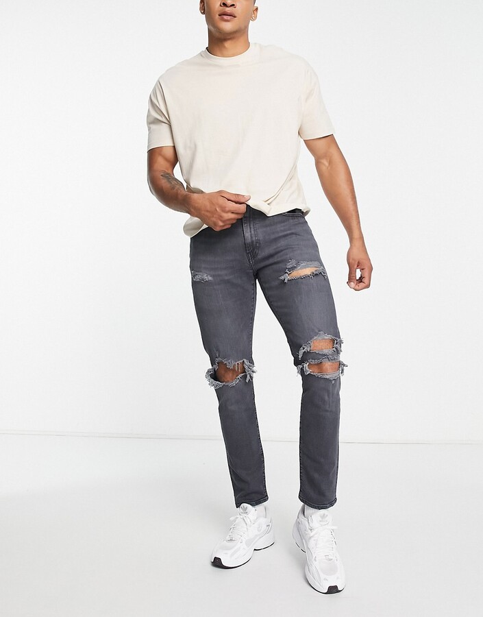 Levi's 512 slim taper jeans with distressing in black wash - ShopStyle