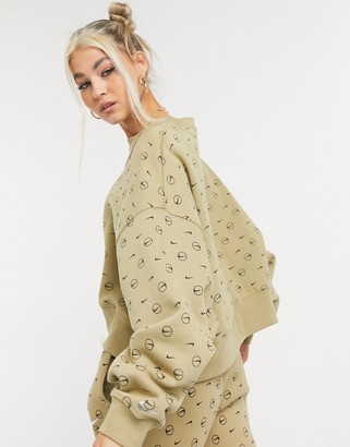 Nike all-over logo print cropped sweatshirt in camel