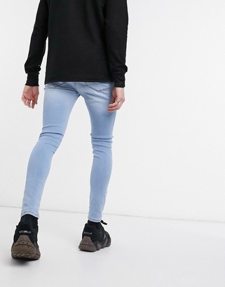 ASOS DESIGN spray on jeans with power stretch in light wash blue - ShopStyle