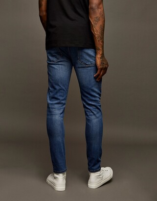 Topman cotton blend stretch slim jeans in mid wash