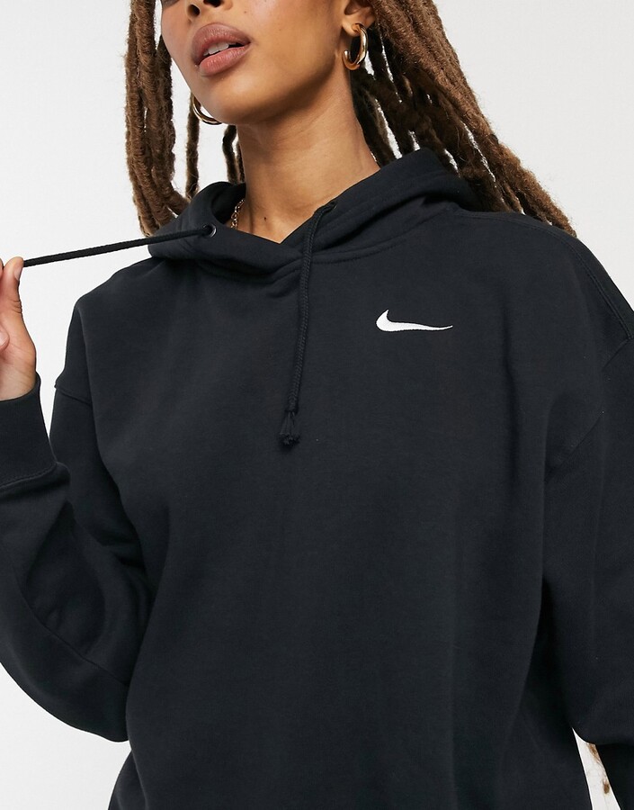 Nike left chest mini swoosh oversized hoodie in black - ShopStyle
