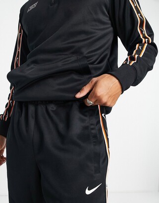 nike repeat pack logo taping polyknit tracksuit in black