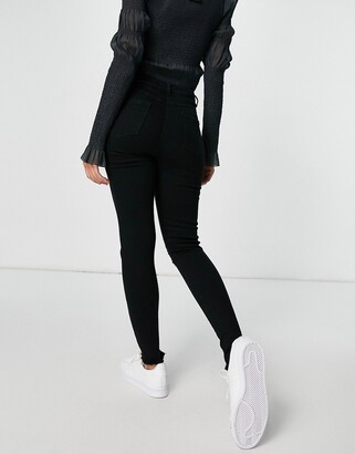 Parisian skinny jeans with ripped knee in black