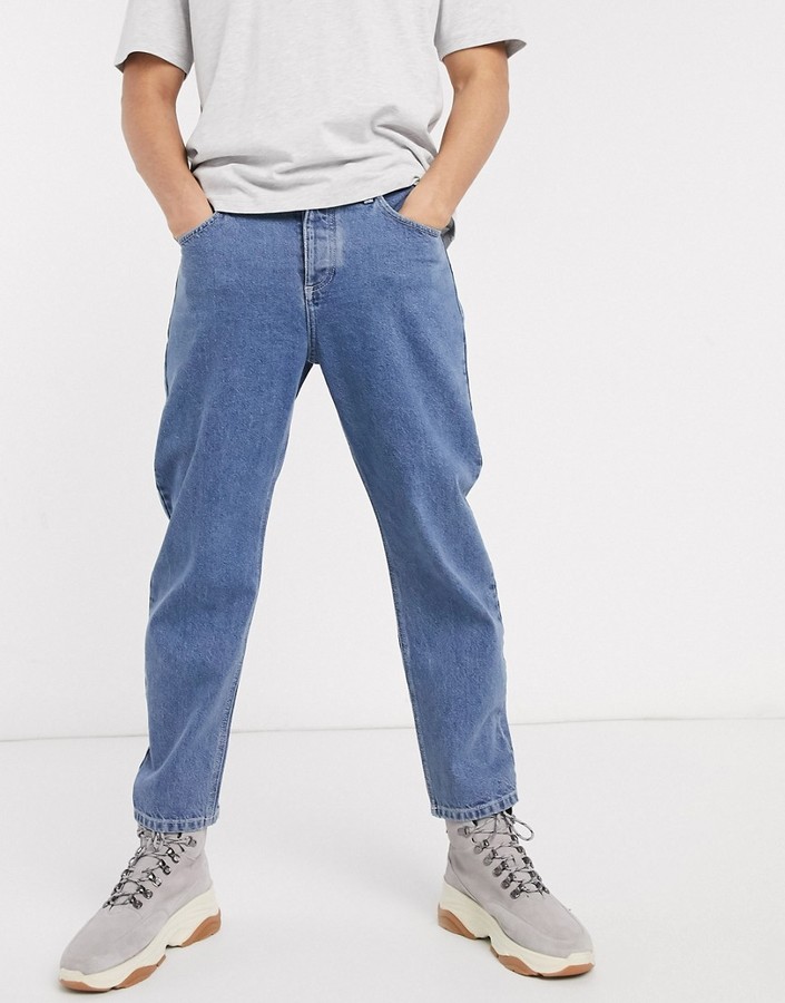 ASOS DESIGN relaxed tapered jeans in mid wash blue - ShopStyle
