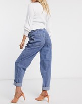 Thumbnail for your product : ASOS DESIGN Maternity tapered boyfriend jeans with d-ring waist detail with curved seams in blue with over the bump bump
