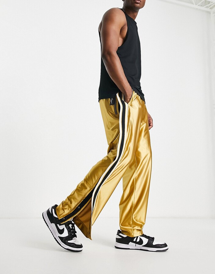 Nike Basketball Circa tear away pants in gold ShopStyle Trousers